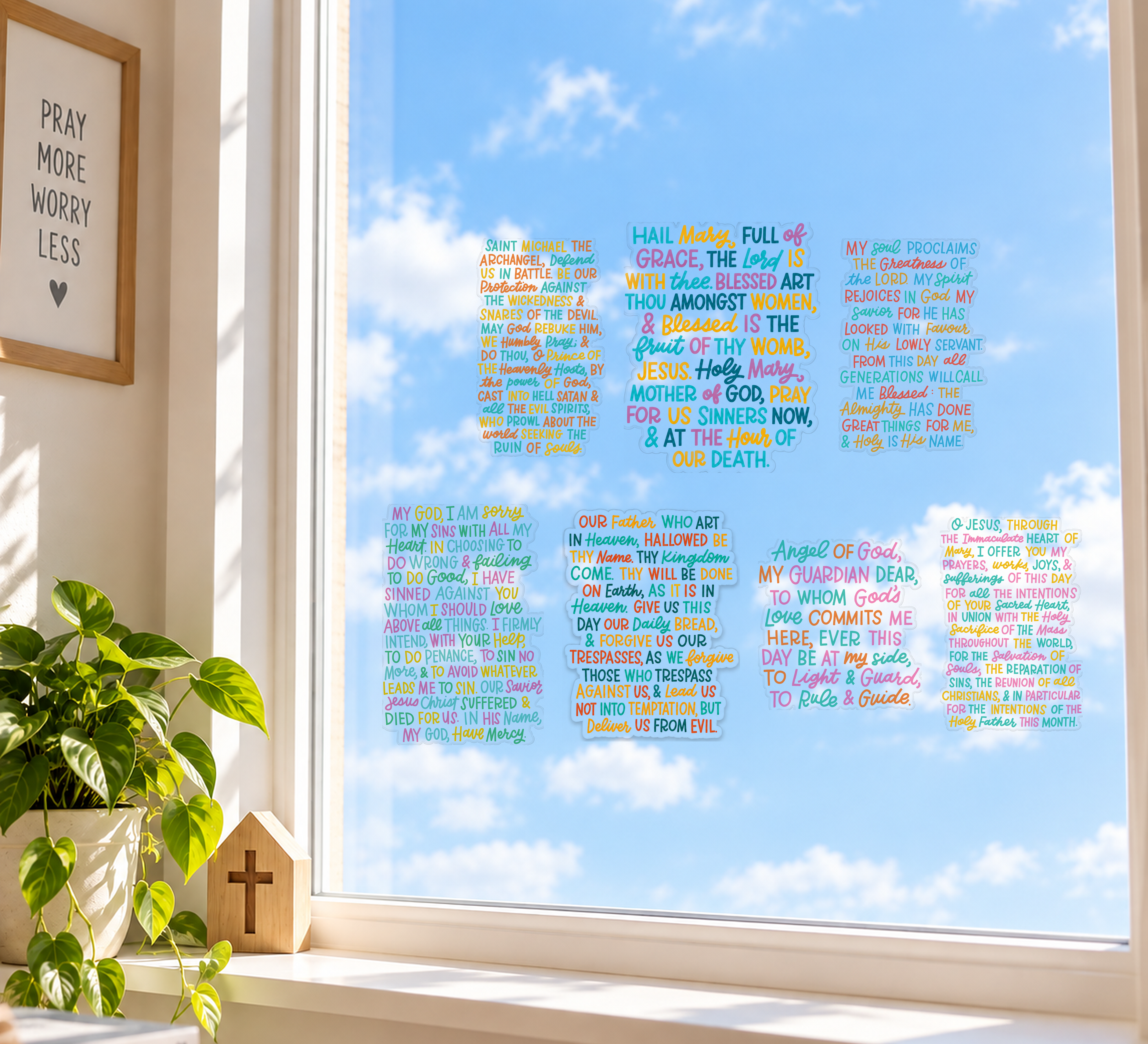 The seven prayer window clings arranged on a bright home window