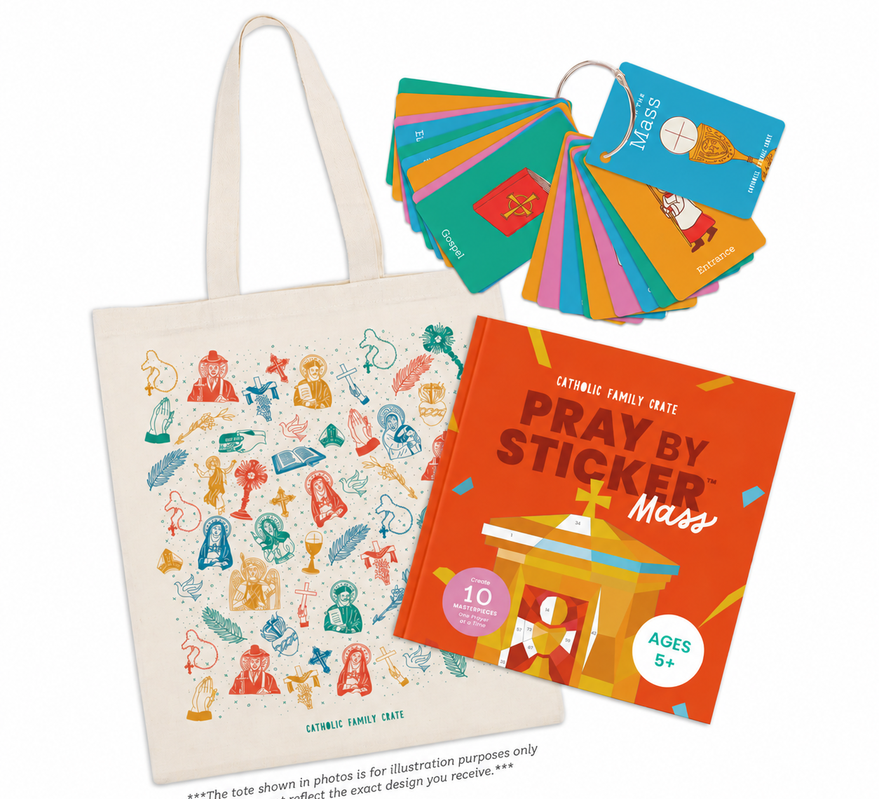 A canvas tote bag printed with colorful religious illustrations, shown with a fanned-out set of matching colorful cards and an orange book titled 'Pray by Sticker Mass'.