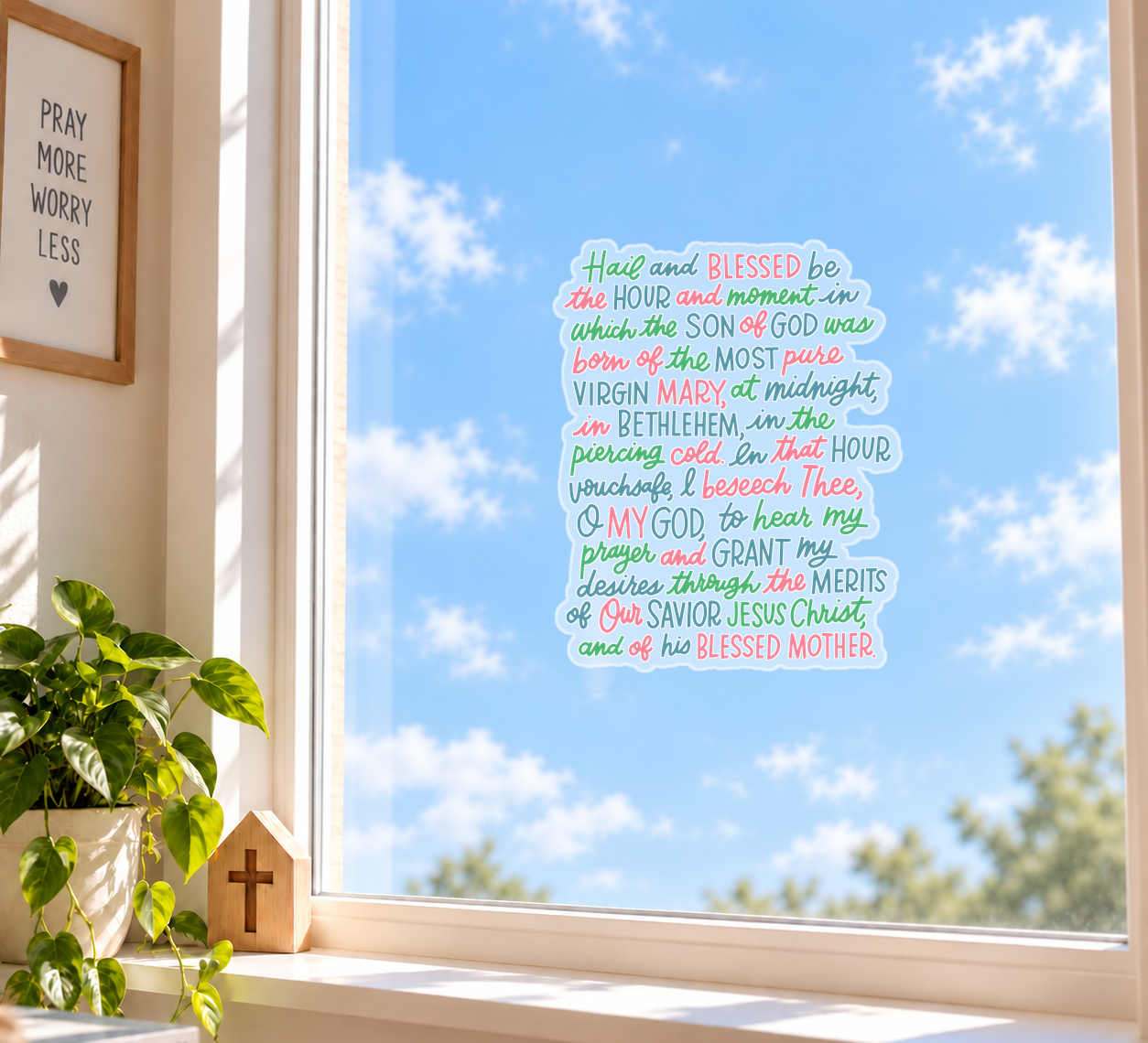 St. Andrew Christmas Novena Window Cling displayed on a sunny window