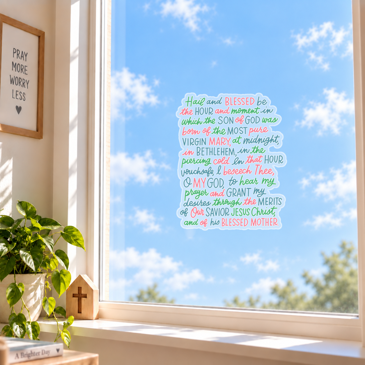 St. Andrew Christmas Novena Window Cling displayed on a sunny window